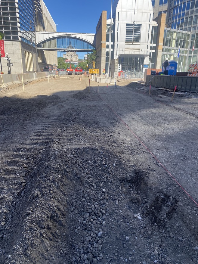 Crews grade 6th Street in preparation to repour the roadway in Downtown St. Paul