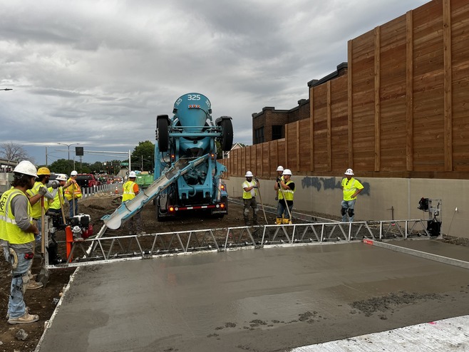 Crews pour concrete for bus-only lanes along Hudson Road in St. Paul