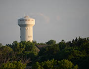 Water tower on forested hilltop