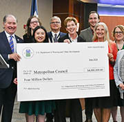 Group of officials with symbolic check.