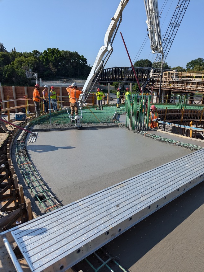 Crews pour concrete for the Maple Street pedestrian bridge