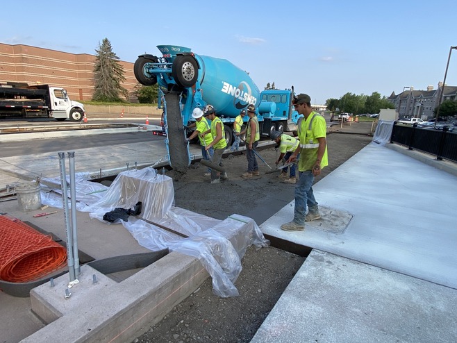 Crews pour concrete for the Queens Station platform