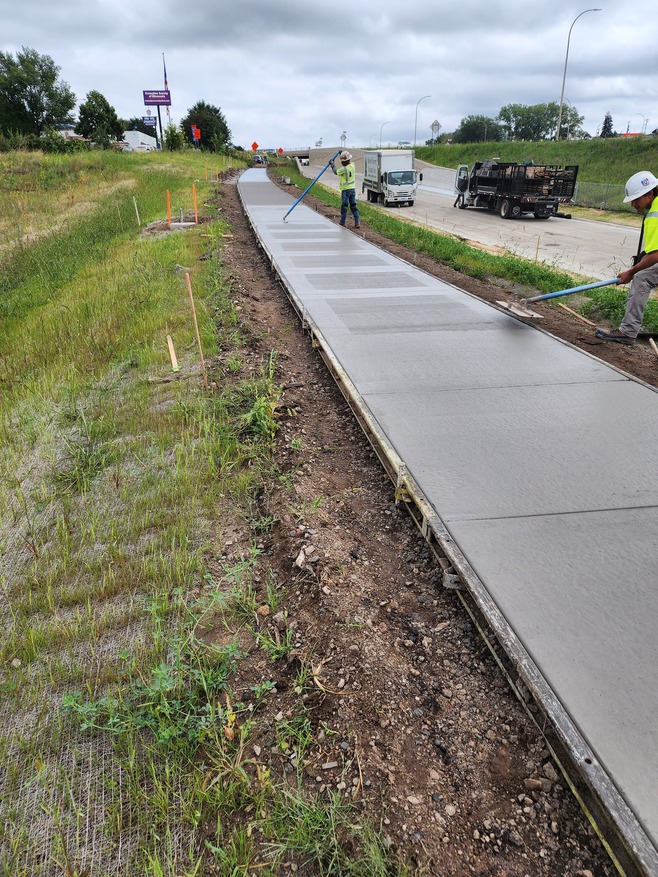 Crews place sidewalks near the Hazel Street Station