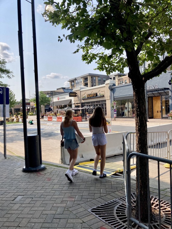 pedestrians walking through e line construction