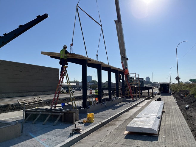 Crews install the roof at Sun Ray station