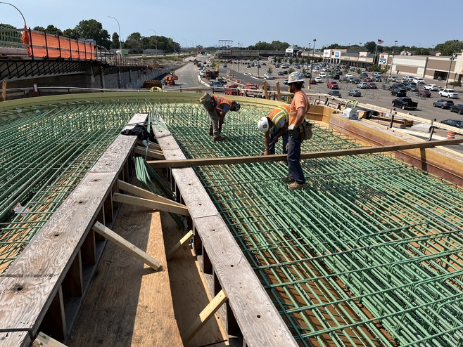 Crews construct the pedestrian bridge over McKnight Road