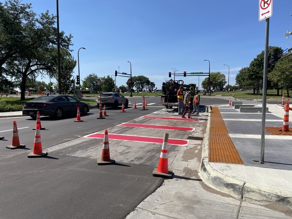 Crews painting a bus only lane on Lake Street