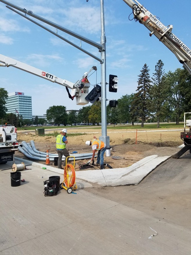 Crews install signal poles at 19th Street and Hudson Road in Maplewood