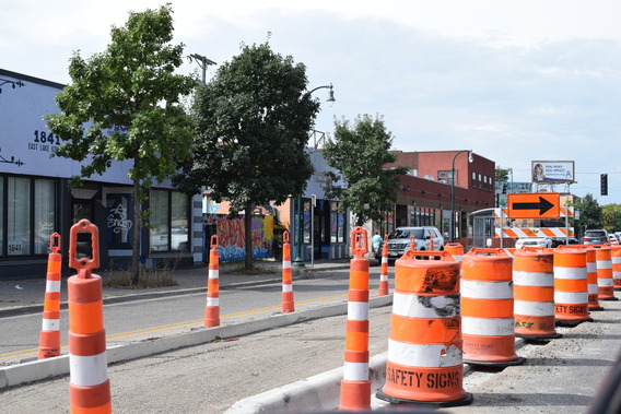 An image of a freshly constructed concrete median on Lake Street with cones around it