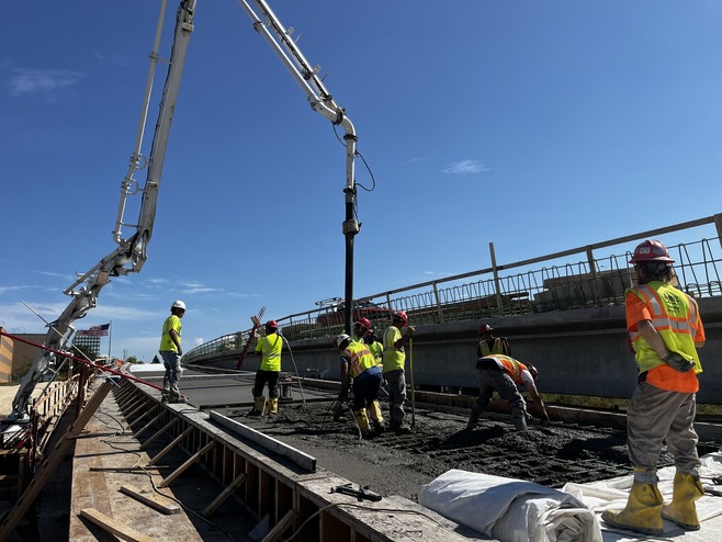 Crews pour concrete for the bridge over Century Avenue/Highway 120