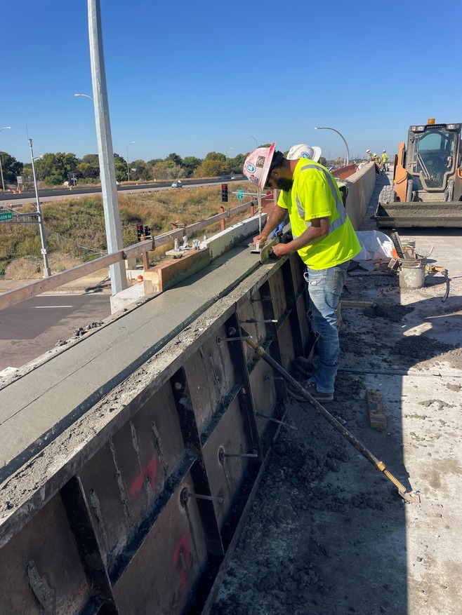 Crews construct bridge railings near Etna Street/Hwy 61