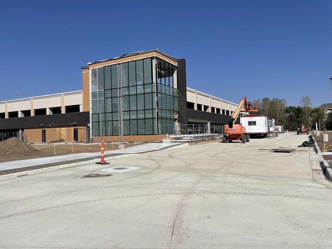 Crews install glass in the Woodlane Park & Ride structure in Woodbury