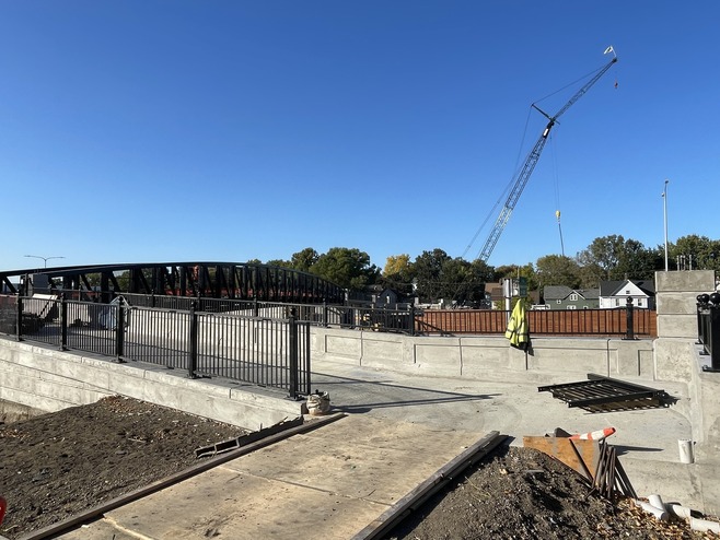 Crews install railings on the Maple Street pedestrian bridge in St. Paul