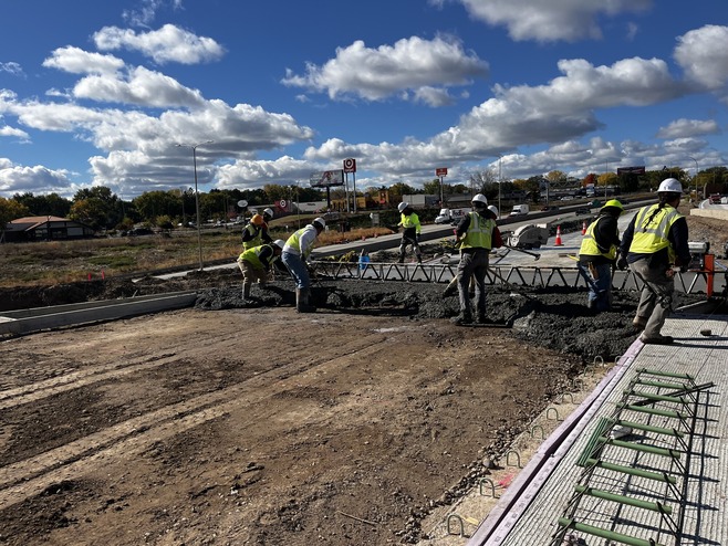 Crews pour concrete for the I-94 westbound on-ramp at White Bear Avenue