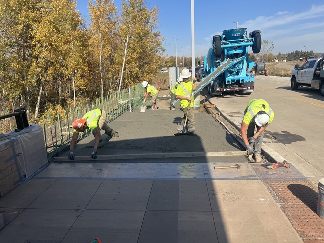 Crews pour concrete along Helmo Avenue in Oakdale