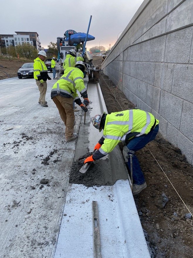 Crews install curbs along the bus guideway near the Hazel Street station