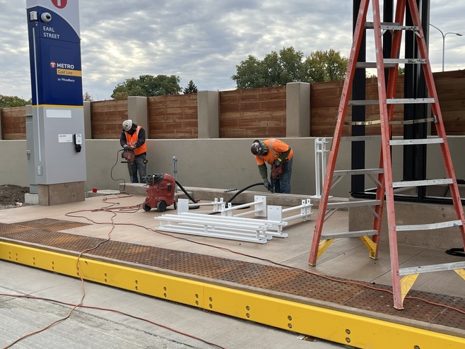 Crews install railings at the Earl Station