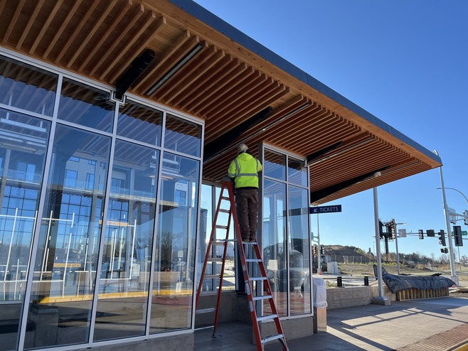 Crews install glass at the Helmo Station