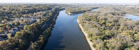 Photo of a river with housing on the banks