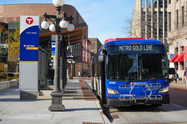 A Gold Line bus stopped at a Gold Line station at Rice Park