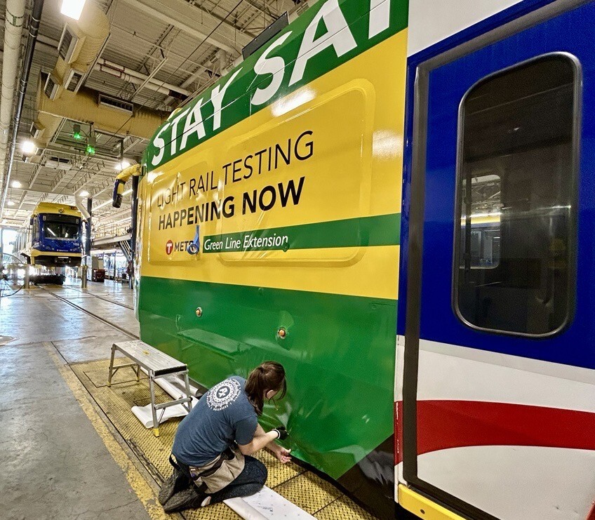 Light rail vehicle being wrapped.
