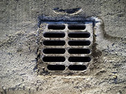 A stormdrain caked with salt.