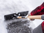 Closeup of a shovel moving snow.