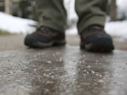 Icy pavement with salt scattered on top.
