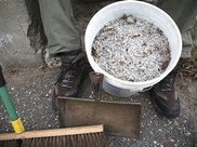 A bucket filled with leftover salt and sand.
