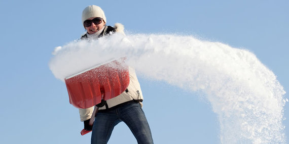 A woman shoveling snow.
