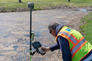 Contractor conducting land survey at the Columbia Golf Course.