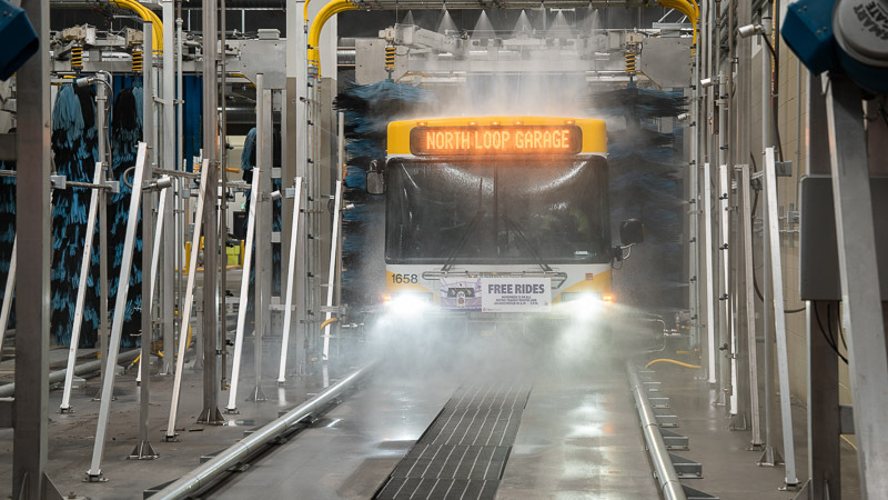 A Metro Transit bus drives through the wash.