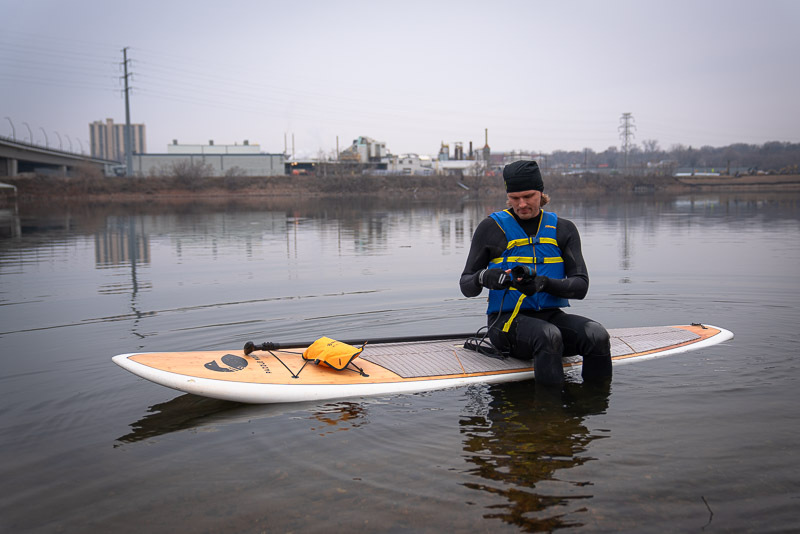 Bryan Boyce dons a wet suit and life jacket as he launches his paddleboard from the MWMO shoreline.