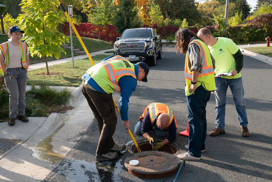 MWMO Staff monitoring at a manhole in the Hoyer Heights neighborhood