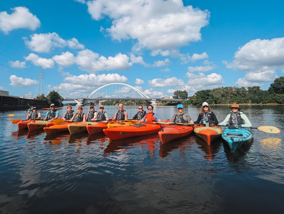 MWMO Staff Paddling by the Lowry Bridge