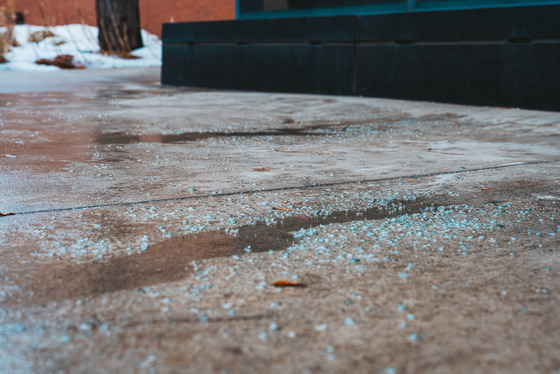 Oversalting in Downtown Minneapolis where rock salt is sitting on top of a wet sidewalk