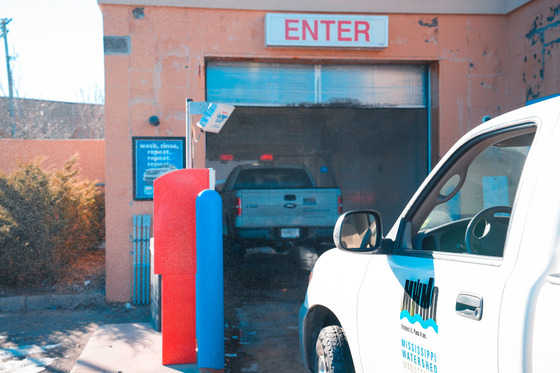 MWMO trucks driving through the commercial car wash