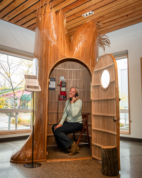MWMO staff posing with the phone in the elm tree story booth at MWMO in 2019