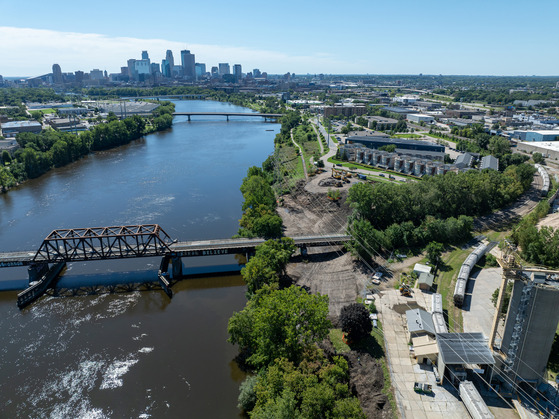 Aerial view of Ole Olson Park construction showing new riverfront trails and habitat restoration along the Mississippi River corridor.