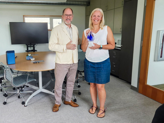 Abby Moore accepting an award from MWMO Executive Director Kevin Reich recognizing her decade of service