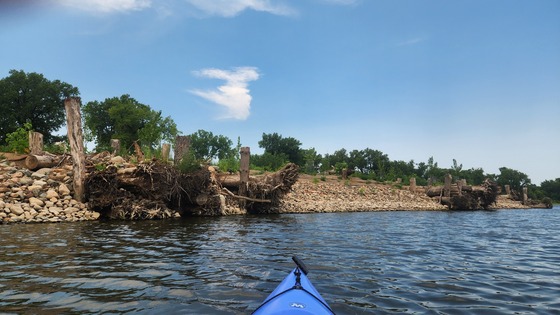 Restoration work in progress at Olson Island with a paddleboard visible in the bottom of the photo