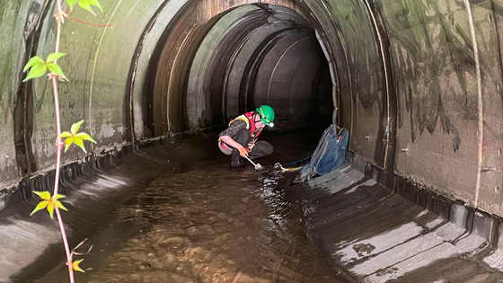 MWMO’s Environmental Monitoring Intern cleans a suction line used to pump stormwater from an underground pipe