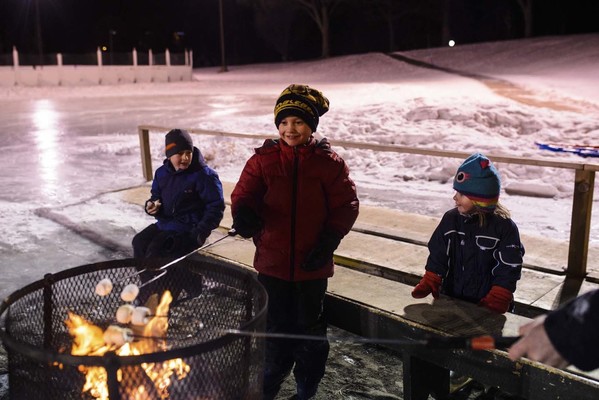Youth roasting marshmallows in winter