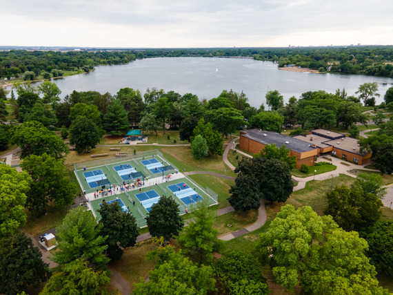 Aerial view of six pickleball courts next to Lake Nokomis Community Center