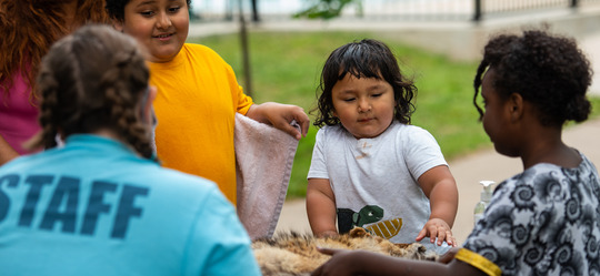 kids with a naturalist at a nature table