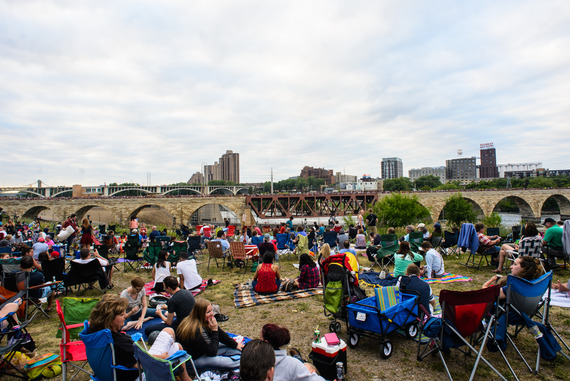 People sit along West River Parkway during Red White and Boom Fourth of July Celebration