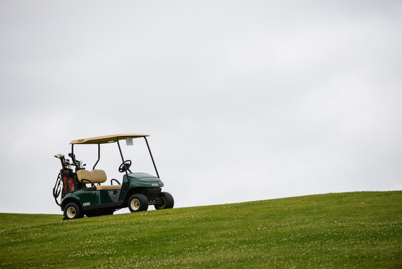 Golf cart at Columbia Golf Course on green grass in July