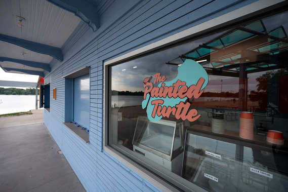 The Painted Turtle text and logo on the window at the Lake Nokomis Main Beach concessions building