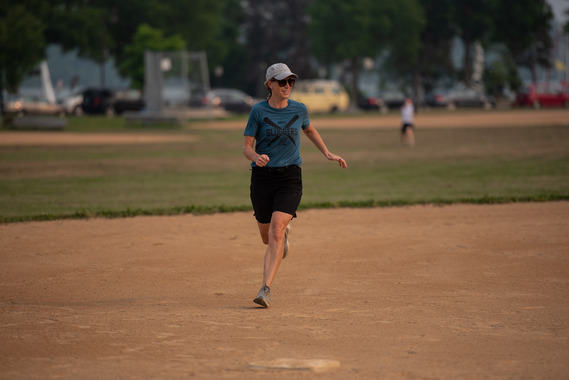 Woman runs on a softball field near Lake Nokomis