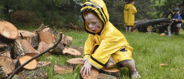 early childhood outdoor exploration with wood pieces